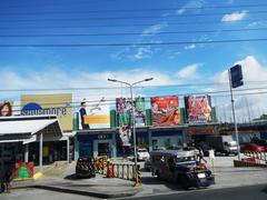 View of Aguinaldo Highway passing through Batulao Village with scenic mountain background