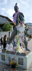 Freddie Mercury statue covered in flowers and messages