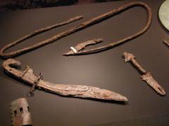 Ancient Iberian weapons including soliferreum, falcata, belt buckle, and shield handle