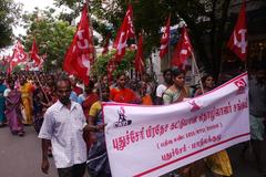 crowd participating in a communist parade