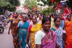 women holding communist flags during a parade