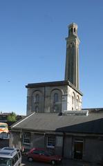 Kew Bridge Steam Engines with tall building housing beam engines, standpipe tower in the background, and boiler house in the foreground