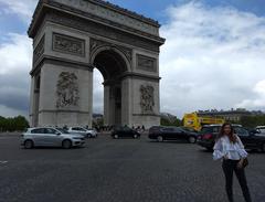 Girl standing in front of Arc de Triomphe, Paris