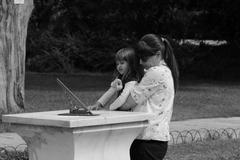 kid and a woman looking at a sundial at National Gardens of Athens