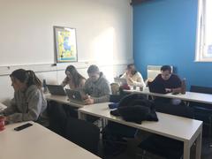 ISEG classroom with rows of white desks and blue chairs