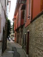 Side street in Turkey with buildings and parked cars