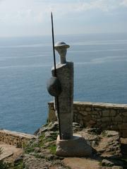 bronze statue of a woman in a cloak