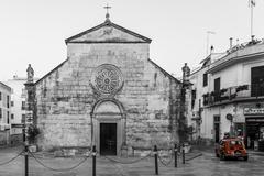 Red Fiat 500 car in front of Church in Locorotondo, Italy