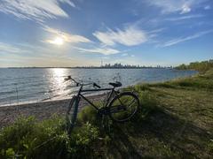 Bicycle at Leslie Street Spit beach during sunset with downtown Toronto in the background