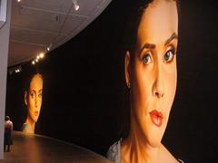 Barbican Art Gallery featuring Shirana Shahrazi's curve art with large photographed faces on a curved wall