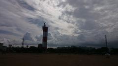 Chennai Lighthouse silhouette at Marina Beach during sunset