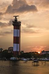 Chennai Lighthouse during monsoon with cloudy sky and turbulent sea