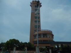 Lighthouse within a marina setting with boats and calm waters