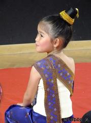 Portrait of a young Laotian child in traditional dance costume during Buddha festival in Strasbourg