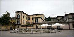 Aerial view of Lucca, Italy showcasing red-roofed buildings and historic architecture