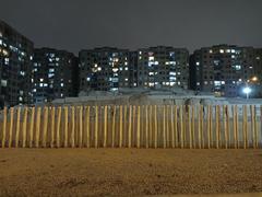 Front view of Huaca Huantinamarca with eucalyptus wood fence