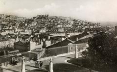 Panoramic view of Lisbon, Portugal with cityscape, rooftops, and the 25 de Abril Bridge in the background