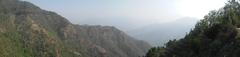 view of Mussorie hill station with lush green mountains and scattered buildings