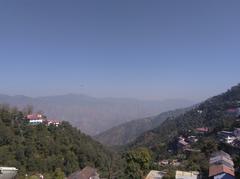 Scenic view of Mussoorie hill station with lush green hills and cloudy sky