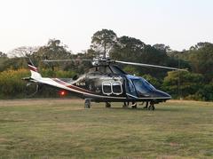 Black Agusta AW109SP helicopter parked