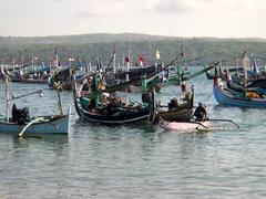 Fishing boats returning in late afternoon at Jimbaron, Bali