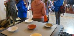 Participants at La Marche Bleue picnic in the Ariana park, seeking shelter from the rain in the Ariana museum