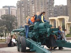 At the October War Panorama exhibit, a family enjoys an outdoor artillery display.