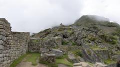 Macchu Picchu ancient ruins under cloudy sky