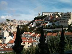 Aerial view of Lisbon with prominent red-roofed buildings and the Tagus River in the background