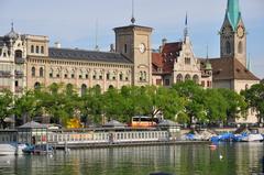 View from Quaibrücke in Zürich towards Zürichsee showing Frauenbadi, Limmat River, Stadthausquai, Fraumünsterpost, Stadthaus Zürich, and Fraumünster