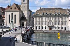 Fraumünster and Zunfthaus zur Meisen at Münsterhof square in Zürich seen from Grossmünsterplatz with Münsterbrücke crossing Limmat river in the foreground