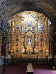 Capilla de los Novicios with ornate vaulted ceiling and baroque altarpiece