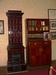 Ceramic stove and Freud's bookcase in the waiting room of his Vienna office