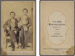 Norwood and African-American boy in a post-Civil War studio portrait