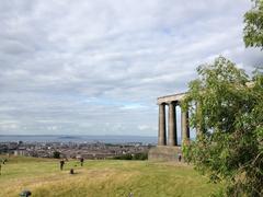 Edinburgh cityscape on a sunny day, showcasing historic buildings and greenery