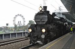 310.23 steam locomotive with special train at Wien Praterstern station with Riesenrad in the background