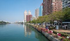 Scenic view of Love River with tree-lined paths and modern buildings in Kaohsiung, Taiwan