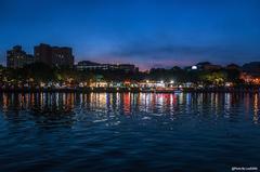 The Love River in Kaohsiung City at dusk with reflections of city lights on the water