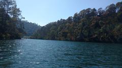 Scenic view of Naukuchiataal Lake with surrounding hills