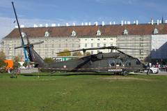 Austrian Armed Forces helicopter flying over a field