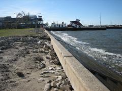 New Basin Canal lighthouse collapsed after Hurricane Katrina, storm surge scour marks in Lakefront Park floodwall, New Orleans