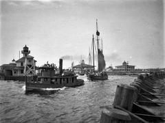 New Basin Canal Lighthouse in New Orleans with steam tug and sailboat