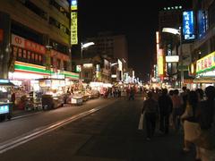 Liouho Night Market at night with illuminated stalls and a street full of people