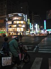 Liouho Night Market in Kaohsiung, Taiwan at night with vibrant lights and bustling crowd