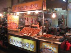 Liouho Night Market in Kaohsiung Taiwan at night with street vendors and shoppers