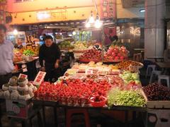 Liouho Night Market in Kaohsiung at night with illuminated stalls and a bustling crowd