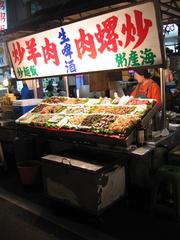 Liouho Night Market in Kaohsiung at night with busy street vendors and visitors