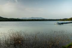 Bañolas Lake with scenic view of calm water and green surroundings