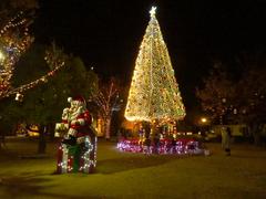 Christmas tree and Santa Claus statue at night in Noritake Garden