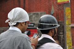 Bikers using mobile phone in Kolkata